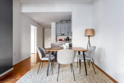 a kitchen and dining room with a table and chairs at Chelsea 1BR w Gym Concierge nr Penn Station NYC-438 in New York
