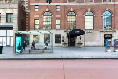 a store front with a bench in front of a building at Chelsea 1BR w Gym Concierge nr Penn Station NYC-438 in New York