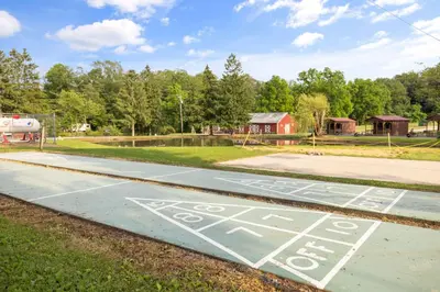 a parking lot with a bus stop sign on it at Cozy Cabin Within Campground in Mifflinburg