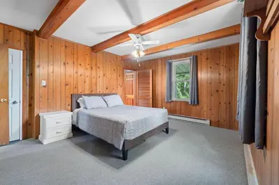 a bedroom with a bed and a ceiling fan at Entire House within Campground in Mifflinburg