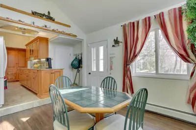 a kitchen and dining room with a table and chairs at Milford Family Home with Koi Pond and Porch! in West Milford