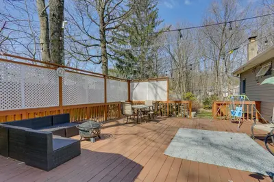 a deck with a grill and a table and chairs at Milford Family Home with Koi Pond and Porch! in West Milford