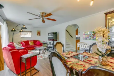 a living room with a red couch and a table at Milford Family Home with Koi Pond and Porch! in West Milford