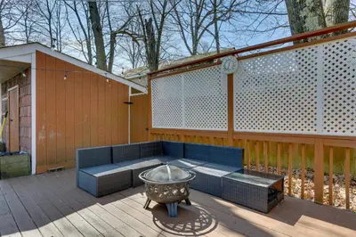 a patio with a couch and a grill on a deck at Milford Family Home with Koi Pond and Porch! in West Milford