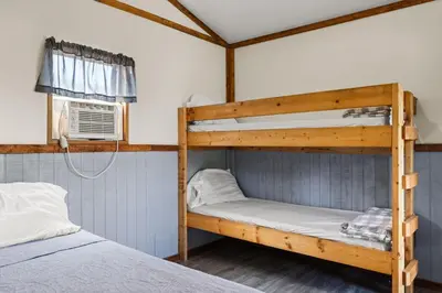 two bunk beds in a room with a window at Cozy Cabin2 Within Campground in Mifflinburg