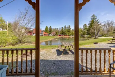 a view of a lake from a porch at Cozy Cabin4 Within Campground in Mifflinburg