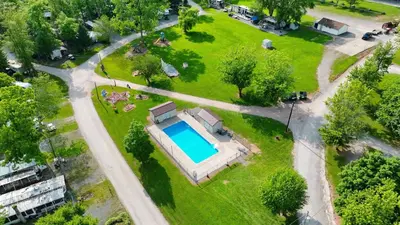an aerial view of a house with a swimming pool in a park at Deluxe Cabin6 Within Campground in Mifflinburg