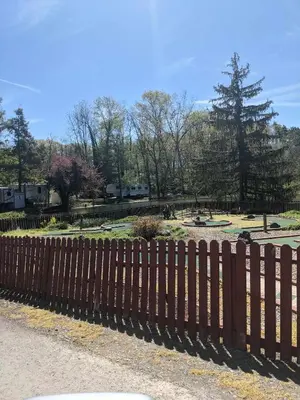 a wooden fence in front of a park at Deluxe Cabin7 Within Campground in Mifflinburg