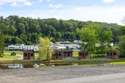 a view of a campground with a pond and trees at Cozy Cabin3 Within Campground in Mifflinburg