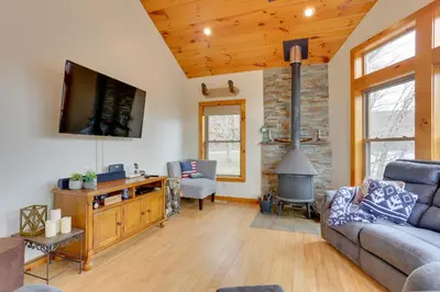 a living room with a couch and a fireplace at Pet-Friendly Hancock Home on the Delaware River! in Starlight
