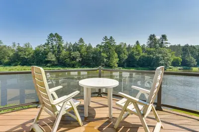 a white table and two chairs on a deck with water at Pet-Friendly Hancock Home on the Delaware River! in Starlight