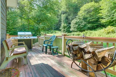 a deck with two chairs and a grill on it at Pet-Friendly Hancock Home on the Delaware River! in Starlight