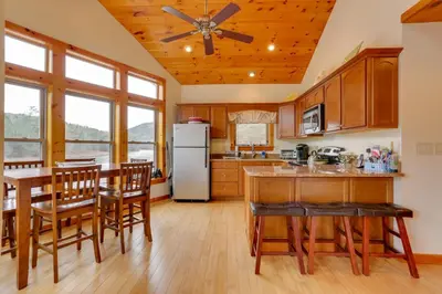 a kitchen with a table and chairs and a refrigerator at Pet-Friendly Hancock Home on the Delaware River! in Starlight