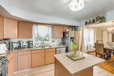 a kitchen with wooden cabinets and a counter top at 3 Mi to Lake Redman Home with Furnished Pergola! in York