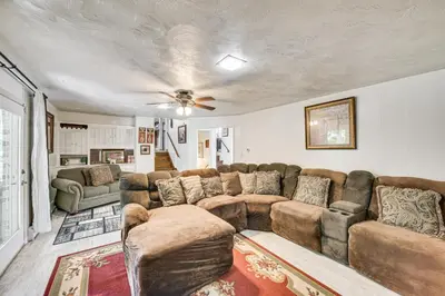 a living room with a couch and a ceiling fan at 3 Mi to Lake Redman Home with Furnished Pergola! in York