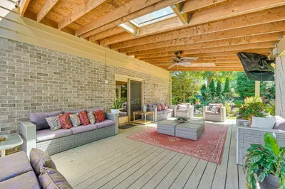 an outdoor living room with couches and a wooden ceiling at 3 Mi to Lake Redman Home with Furnished Pergola! in York