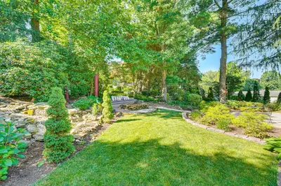 a garden with grass and trees and a pathway at 3 Mi to Lake Redman Home with Furnished Pergola! in York