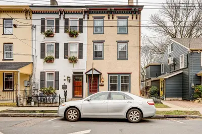 a silver car parked in front of a house at Brooke House In The Heart of Downtown with Patio! in Lambertville