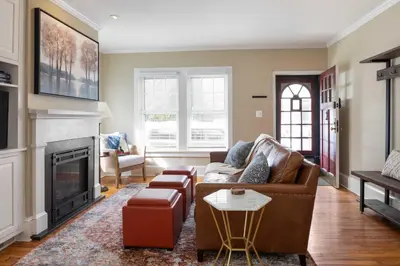 a living room with a couch and a fireplace at Brooke House In The Heart of Downtown with Patio! in Lambertville