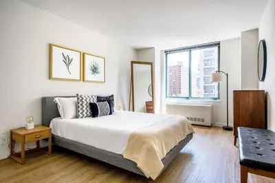 a bedroom with a large white bed and a window at UWS 1BR w Doorman Gym Parking nr Central Park NYC-596 in New York