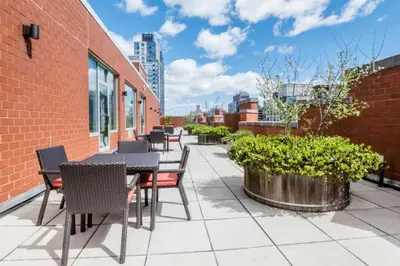 a patio with tables and chairs on a building at UWS 1BR w Doorman Gym Parking nr Central Park NYC-596 in New York