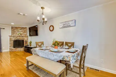 a dining room with a table and chairs and a fireplace at Wilmington Vacation Rental Less Than 2 Mi to Downtown! in Wilmington