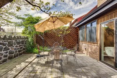 a patio with a table and chairs and an umbrella at Wilmington Vacation Rental Less Than 2 Mi to Downtown! in Wilmington