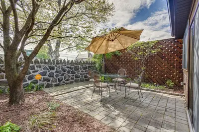 a patio with a table and an umbrella at Wilmington Vacation Rental Less Than 2 Mi to Downtown! in Wilmington