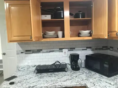 a kitchen counter with a toaster oven and a microwave at Quite and Spacious Apartment in Elizabeth