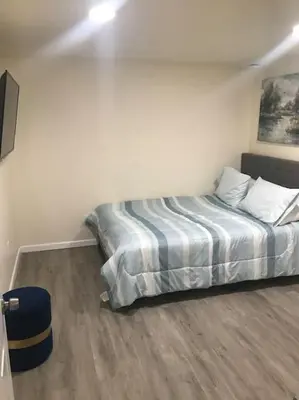 a bedroom with a bed in the corner of a room at Quite and Spacious Apartment in Elizabeth
