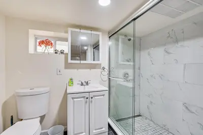 a bathroom with a shower and a toilet and a sink at Quite and Spacious Apartment in Elizabeth