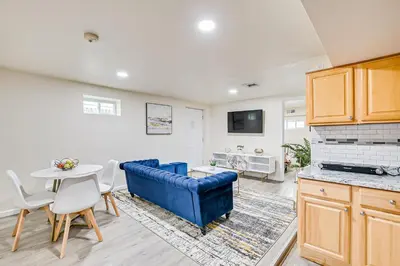 a living room with a blue couch and a table at Quite and Spacious Apartment in Elizabeth