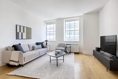 a living room with a couch and a tv at FiDi 1br w lounge gym nr Freedom Tower NYC-1138 in New York