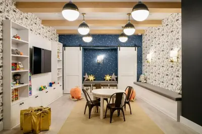 a childrens playroom with a table and chairs at FiDi 1br w lounge gym nr Freedom Tower NYC-1138 in New York