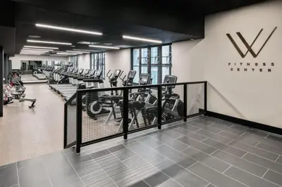 a gym with rows of treadmills and ellipticals at FiDi 1br w lounge gym nr Freedom Tower NYC-1138 in New York