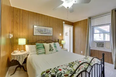a bedroom with a large bed with wooden walls at Scenic Home on the Delaware River, Pet-Friendly! in Starlight