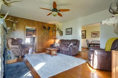 a living room with couches and a ceiling fan at Rustic Wellsville Home - 5 Mi to Roundtop Mountain in Wellsville