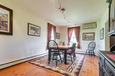 a kitchen and dining room with a table and chairs at Rustic Wellsville Home - 5 Mi to Roundtop Mountain in Wellsville