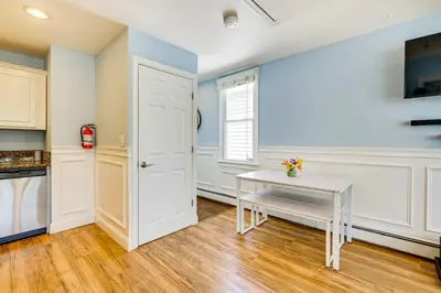 a kitchen with a white table and a window at New Jersey Abode - Near Theme Parks, Walk to Beach in Keansburg