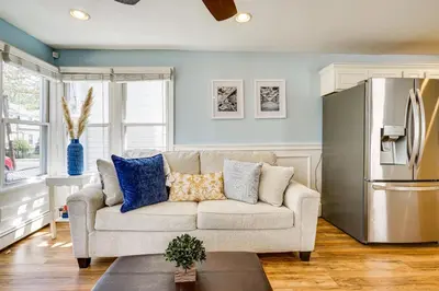 a living room with a couch and a refrigerator at New Jersey Abode - Near Theme Parks, Walk to Beach in Keansburg