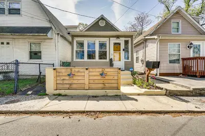 a house with a wooden gate in front of it at New Jersey Abode - Near Theme Parks, Walk to Beach in Keansburg