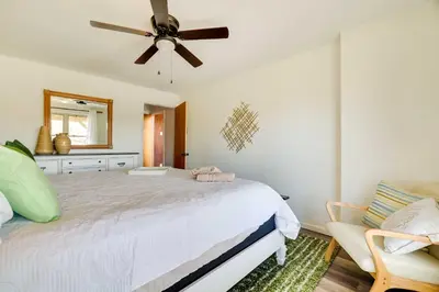 a bedroom with a bed and a ceiling fan at Dock and Fire Pit Lakefront Poconos Retreat! in Long Pond