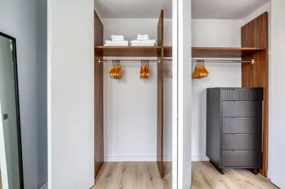 a walk in closet with wooden shelves and a drawer at Midtown 1br w doorman gym wd nr Rock Center NYC-1131 in New York