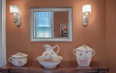 two vases and a bowl on a table with a mirror at Shamokin Bed and Breakfast in Shamokin