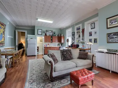 a living room with a couch and a kitchen at Shamokin Bed and Breakfast in Shamokin