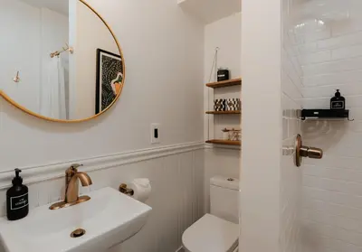 a white bathroom with a sink and a mirror at The Yarra in Roscoe