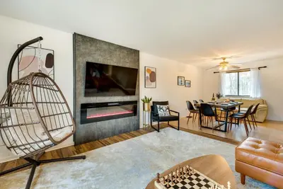 a living room with a fireplace and a dining room at Serene Pocono Pines Home 2 Mi to Lake Naomi Beach in Pocono Pines