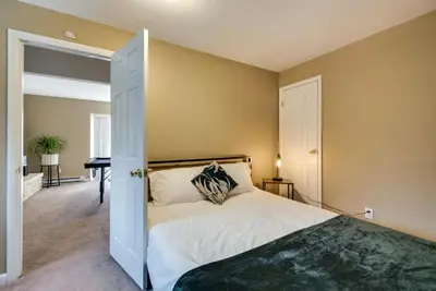 a bedroom with a bed and a door open at Serene Pocono Pines Home 2 Mi to Lake Naomi Beach in Pocono Pines