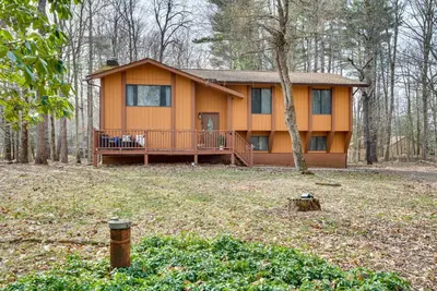 a small house in the middle of a forest at Serene Pocono Pines Home 2 Mi to Lake Naomi Beach in Pocono Pines