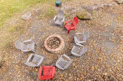 a group of chairs sitting around a fire pit at Waterfront Stagshead Lakehouse at Lake Arrowhead in Arrowhead Lake
